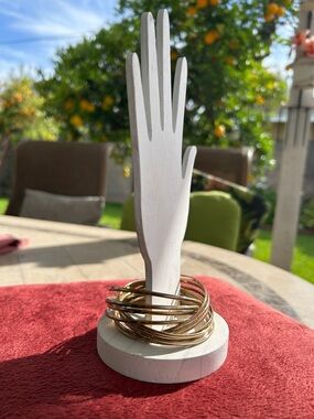 Gold-tone stackable bangles are designed for a minimalist, timeless look.